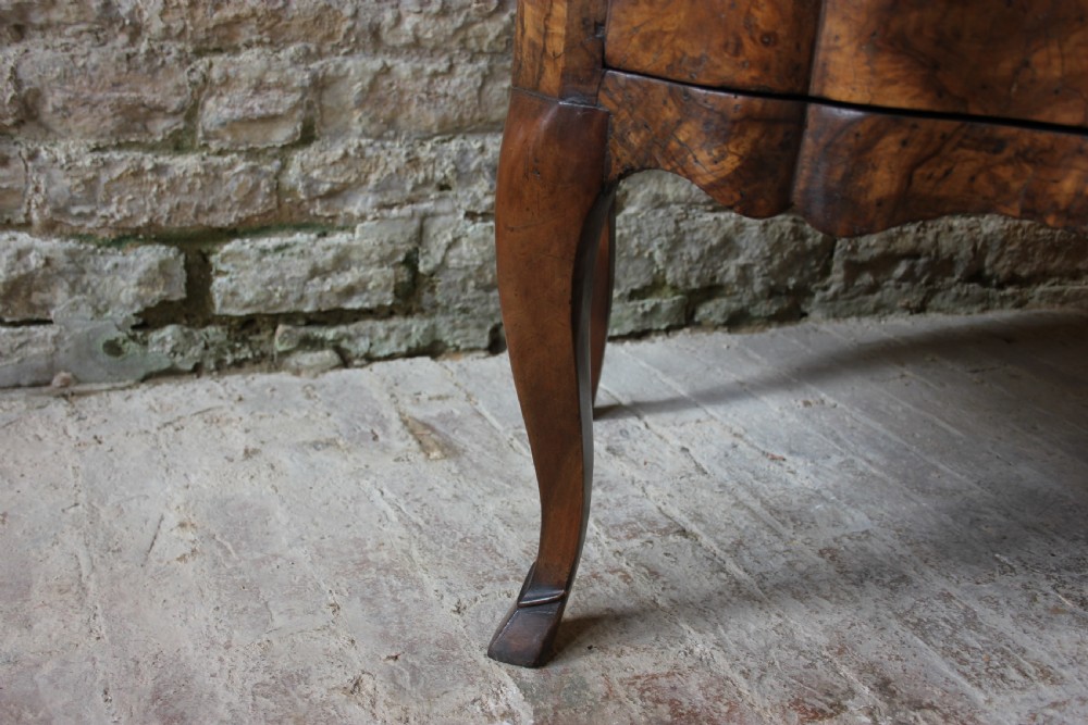 An eighteenth-century Italian walnut commode featuring a serpentine curved front, two panel doors, cabriole legs, and dark metal handles. View VIII