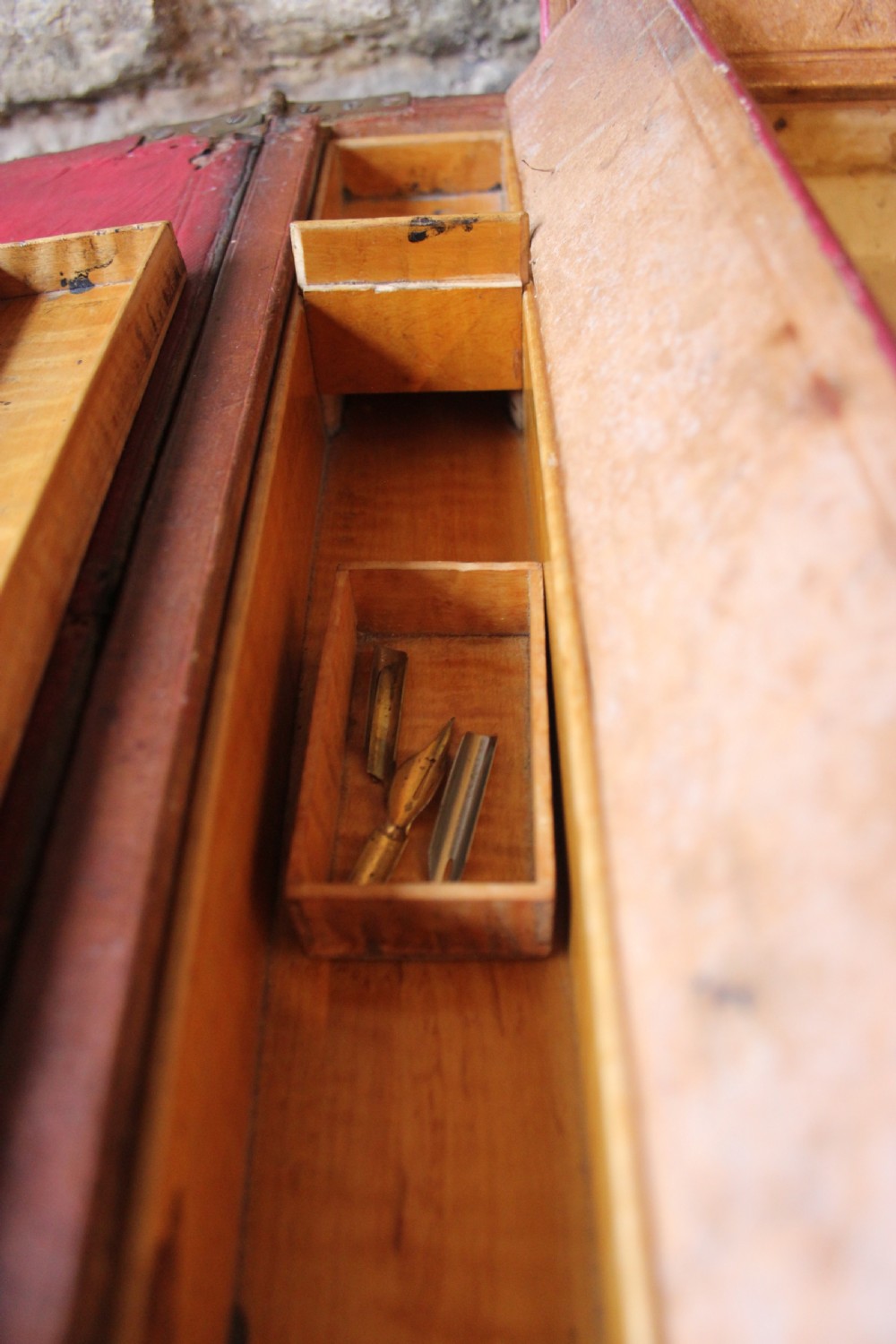 A 19th-century patinated brown leather attache case featuring a top handle, fold-over flap, brass clasp, and decorative embossed detailing around a central brass keyhole. View X