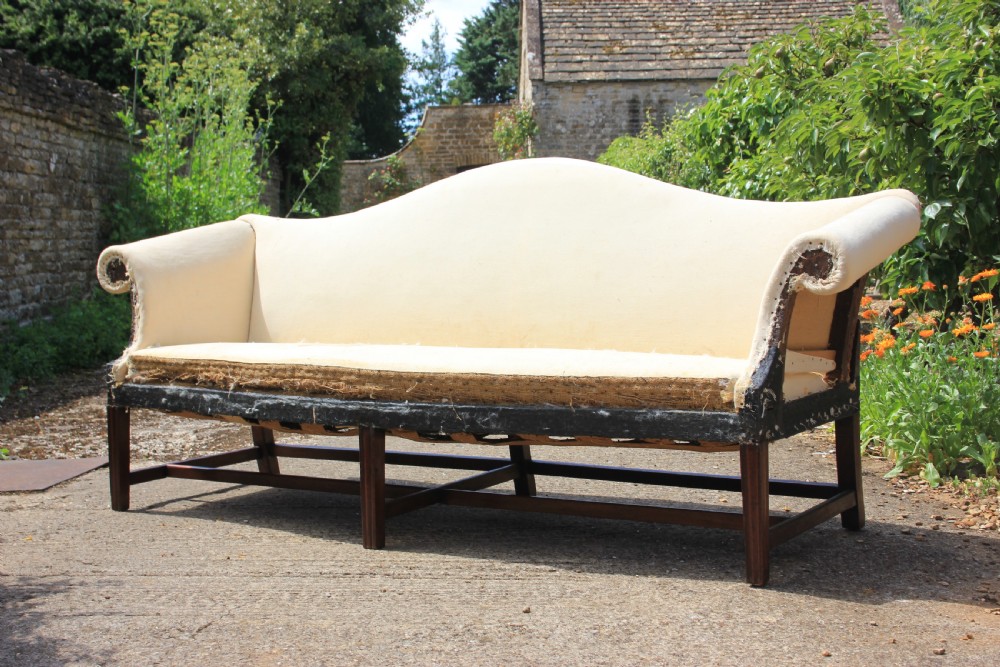 An 18th century, serpentine front camel back sofa