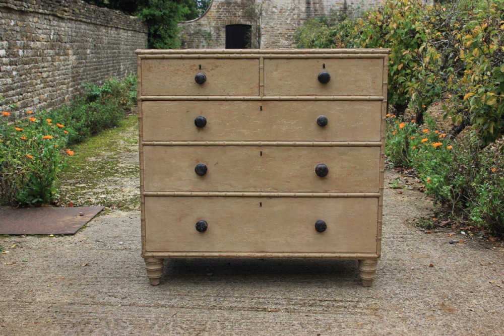An early nineteenth-century painted chest of drawers featuring faux bamboo moulding, dark turned wood knobs, and a two-over-three drawer configuration. View V