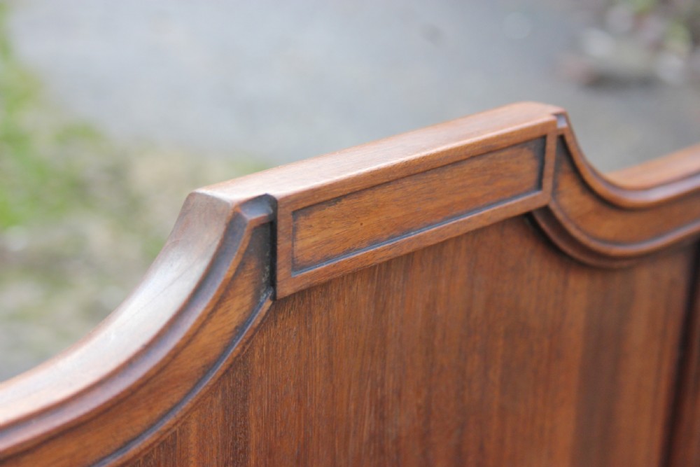 A pair of mahogany hall chairs featuring carved backrests with central circular mouldings, solid timber seats, and fluted turned front legs. View IV