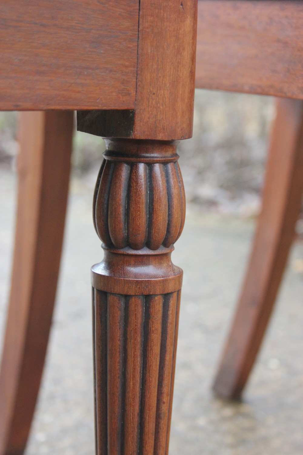 A pair of mahogany hall chairs featuring carved backrests with central circular mouldings, solid timber seats, and fluted turned front legs. View VIII