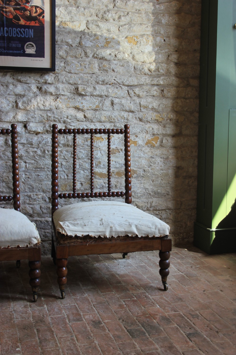 A pair of Victorian low-backed bobbin turned chairs with calico upholstered seats and brass castors. View III