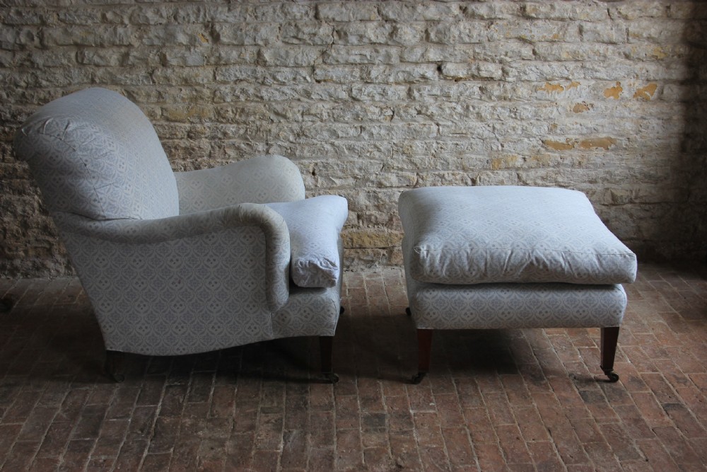 A light blue patterned upholstered Bridgewater armchair paired with a matching rectangular footstool, both raised on tapered mahogany legs with brass castors. View III