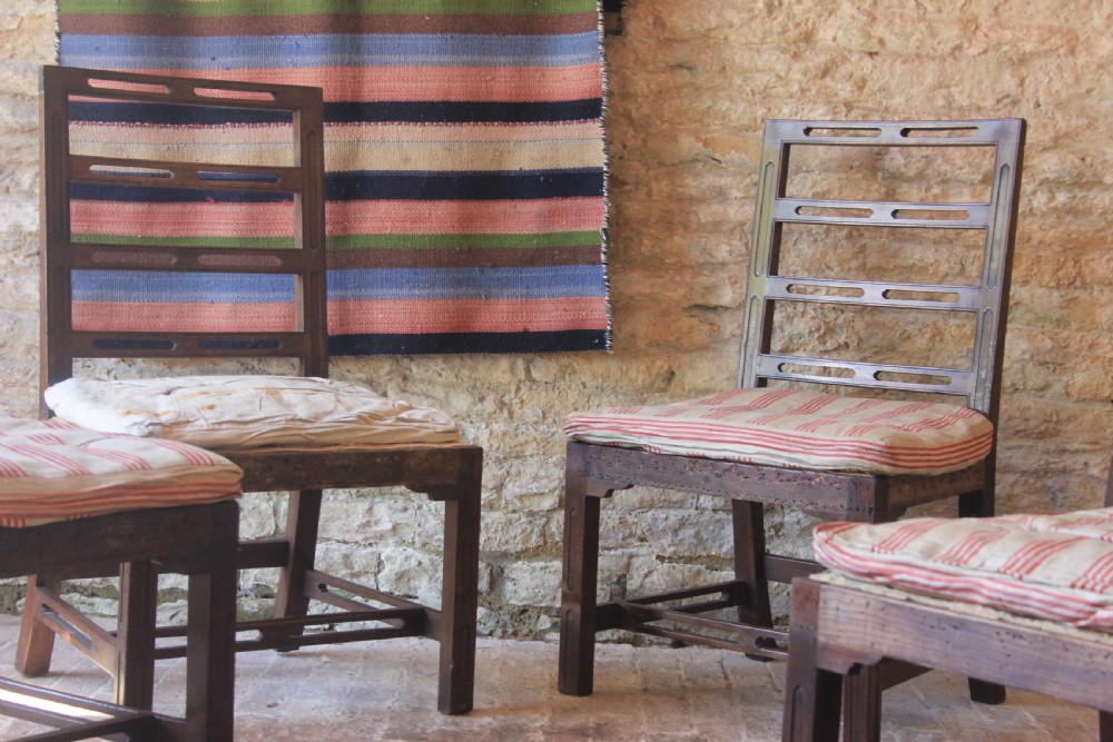 Set of four dark timber 18th-century Irish ladderback dining chairs with slotted horizontal back rails and seat cushions. View II