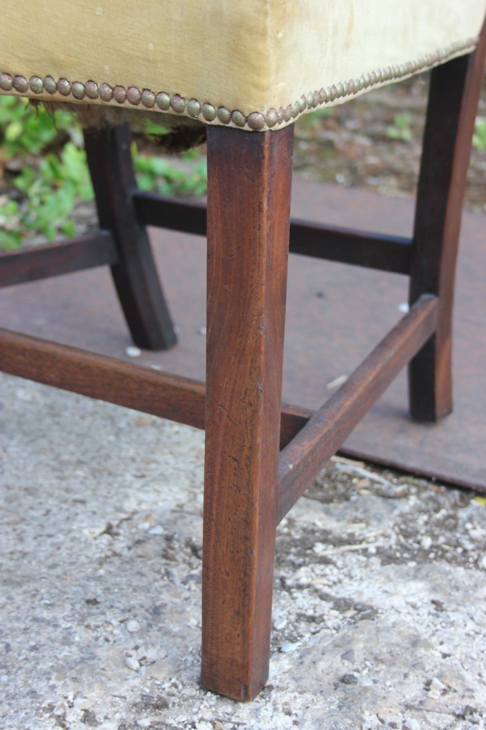 A Georgian dark mahogany dining chair featuring wave-pattern pierced horizontal back rails, a gold velvet upholstered seat with brass studding, and square legs joined by H-stretchers. View III