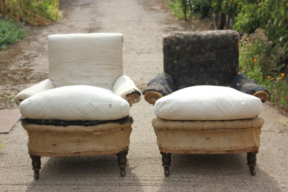 A pair of Victorian deep-seated armchairs in calico upholstery lining with turned timber legs and castors. View II
