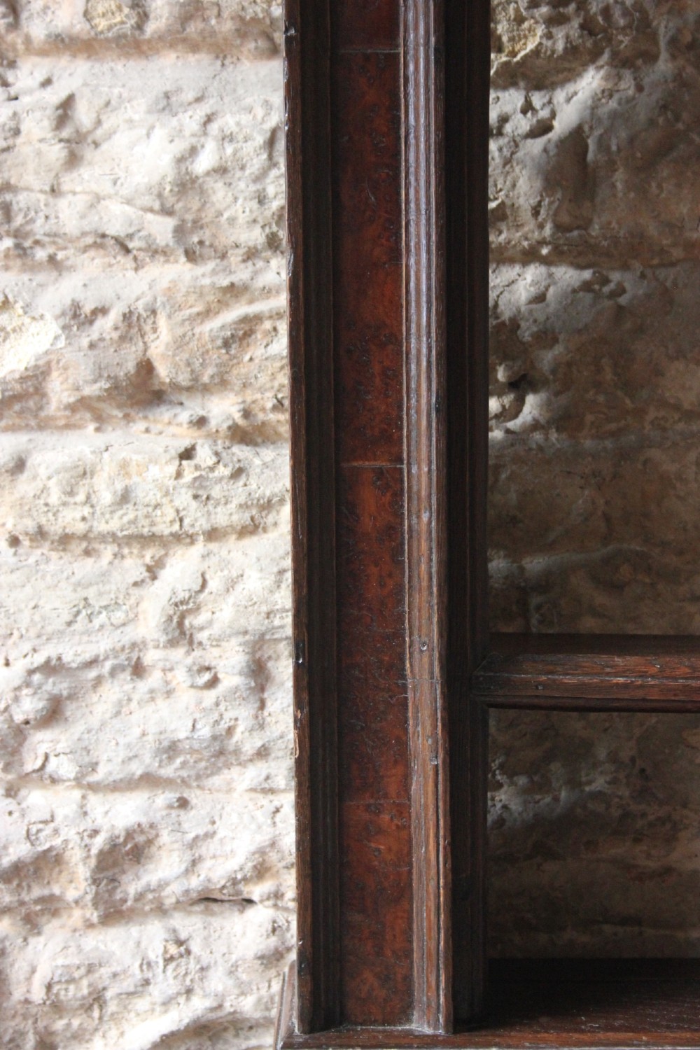 An 18th-century dark oak wall-mounted plate rack featuring a moulded cornice top and two horizontal shelf rails. View II