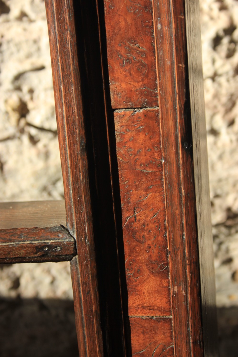 An 18th-century dark oak wall-mounted plate rack featuring a moulded cornice top and two horizontal shelf rails. View III