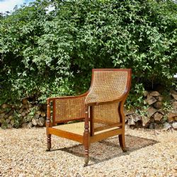 A REGENCY BERGERE ARMCHAIR
