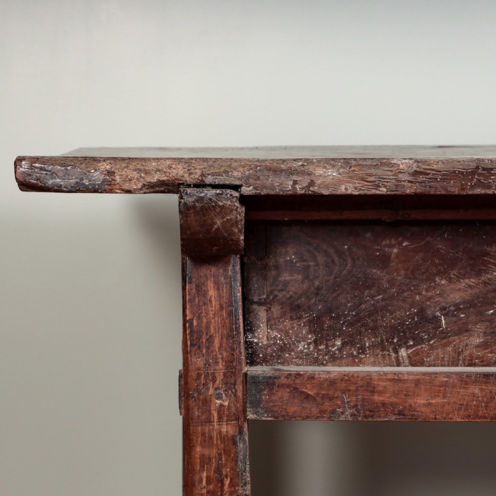 A 17th-century Spanish timber console table featuring two carved drawer fronts with iron ring handles. View IV