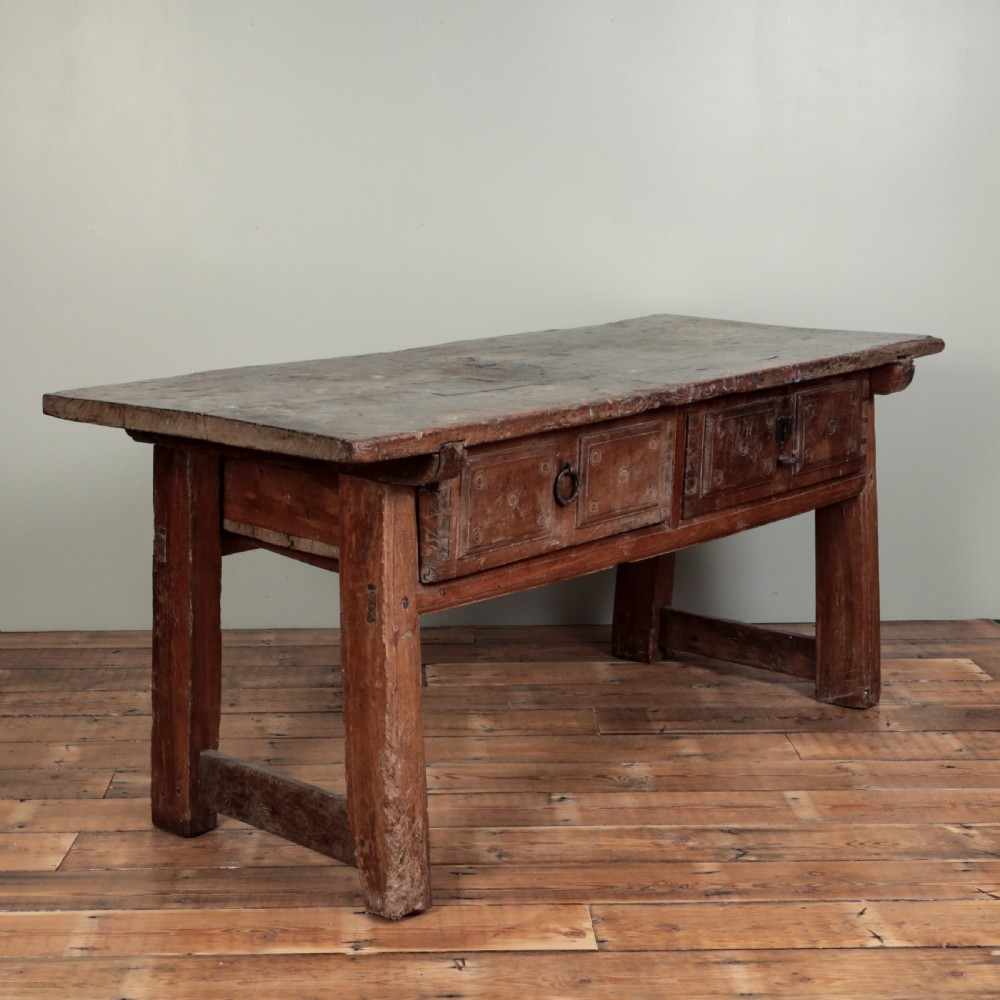 A 17th-century Spanish timber console table featuring two carved drawer fronts with iron ring handles. View V