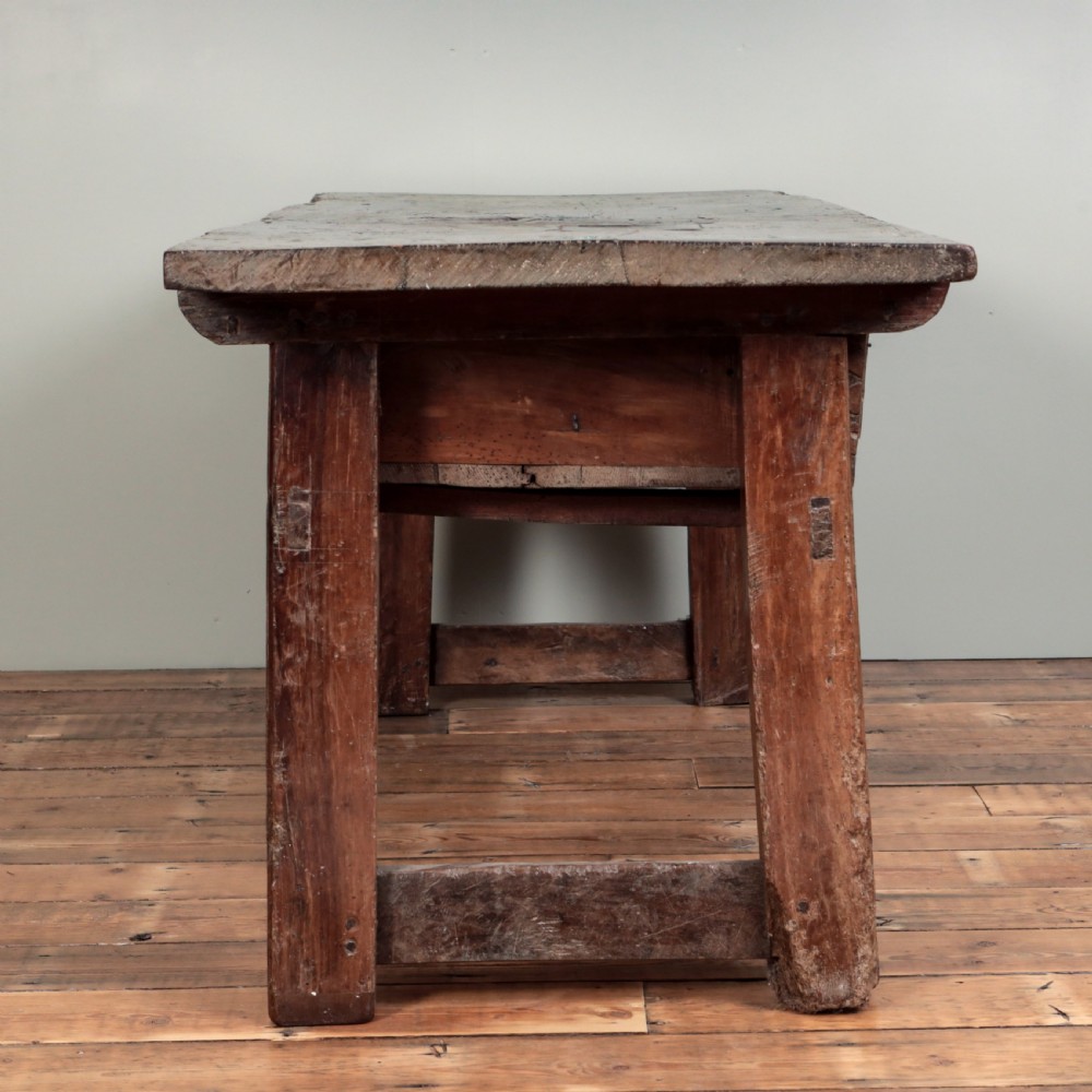 A 17th-century Spanish timber console table featuring two carved drawer fronts with iron ring handles. View VII