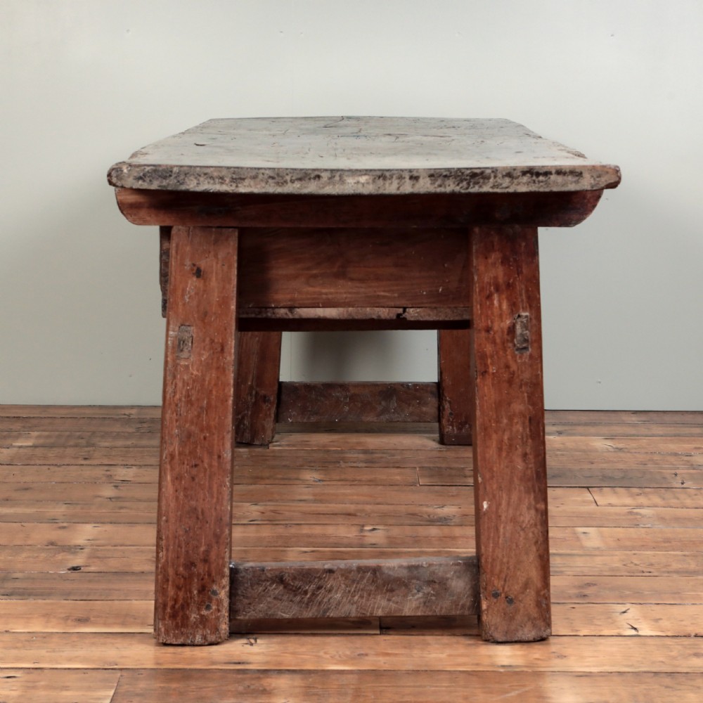 A 17th-century Spanish timber console table featuring two carved drawer fronts with iron ring handles. View X