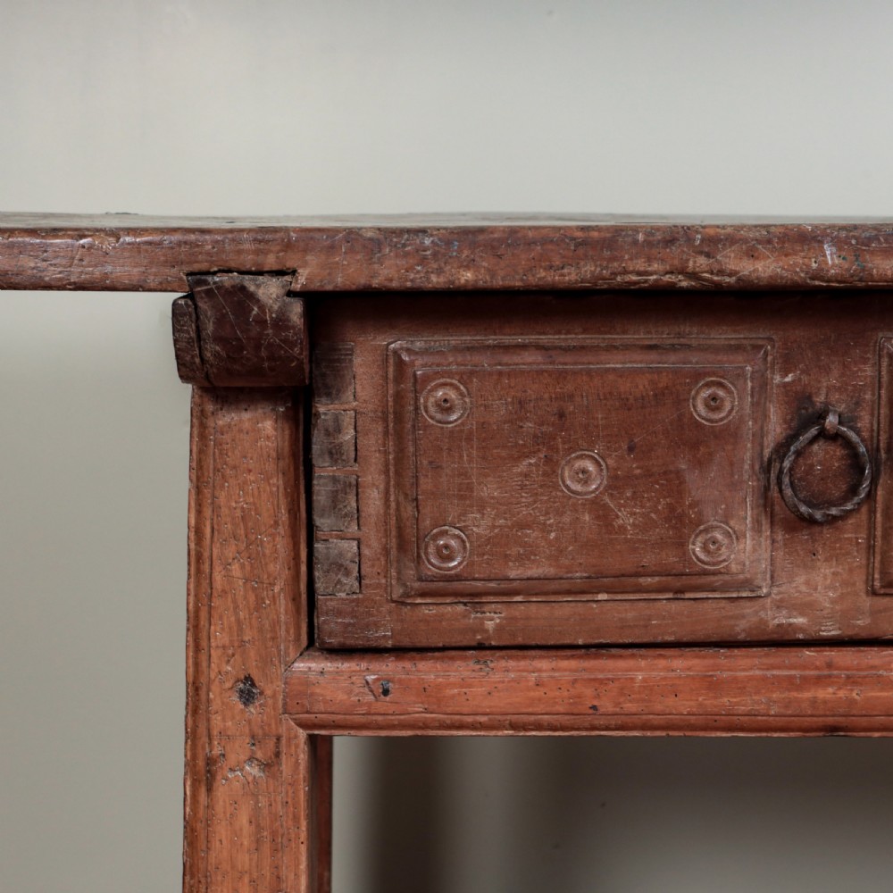 A 17th-century Spanish timber console table featuring two carved drawer fronts with iron ring handles. View XXI