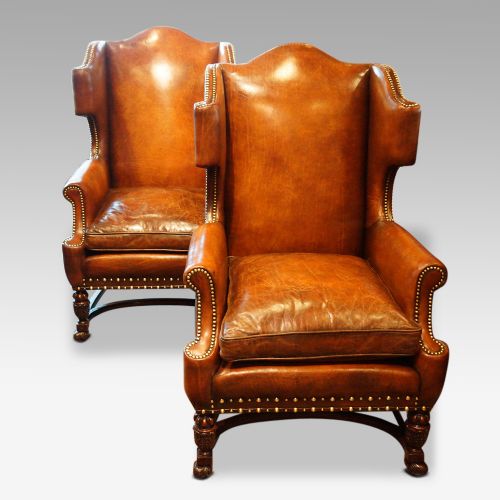 Pair of Carved Oak and Leather Wing Chairs