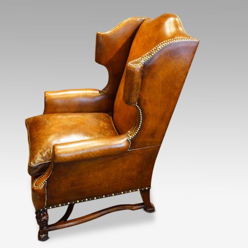 fig 7. Pair of carved oak and leather wing chairs