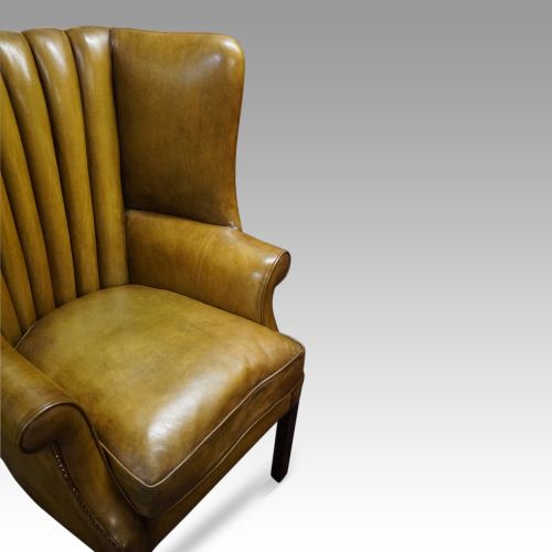 fig 1. Antique leather wing chair