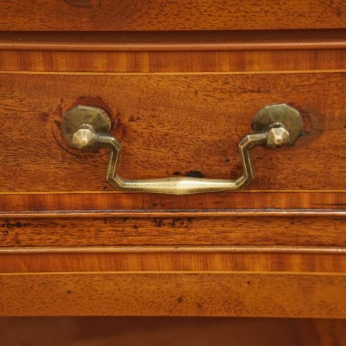 fig 4. A George III mahogany chest featuring four graduated drawers decorated with satinwood banding, brass swan-neck handles, and shaped bracket feet.