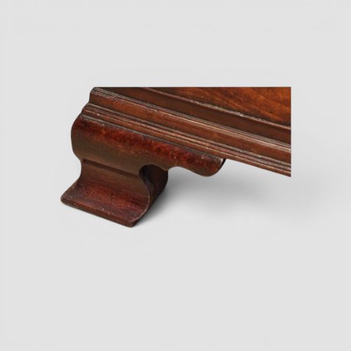 fig 6. A tall George III mahogany chest-on-chest featuring a carved blind fretwork cornice, brass swan-neck handles, and bracket feet.
