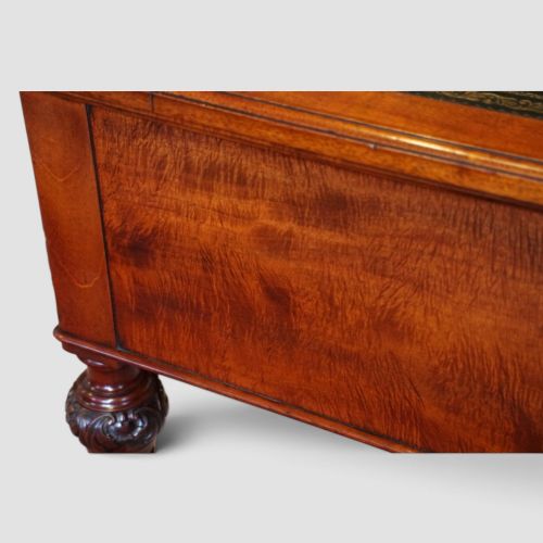 Victorian mahogany writing table featuring a dark green leather top, five drawers with circular wooden handles, turned legs, and brass castors. View XIV