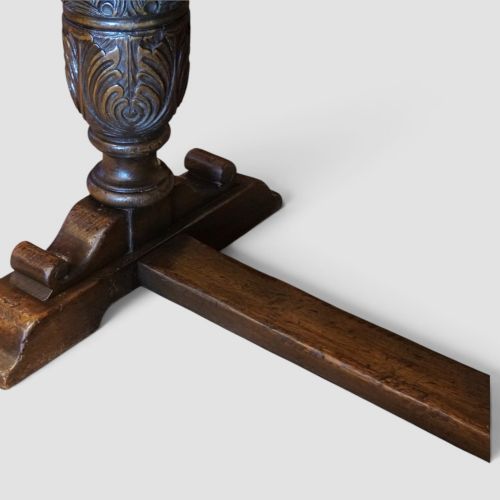 fig 2. A rectangular solid oak refectory dining table featuring turned bulbous pedestal supports connected by a low central stretcher rail.