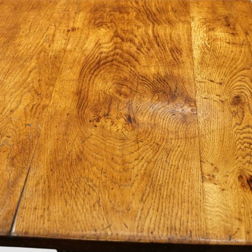 fig 6. A rectangular solid oak refectory dining table featuring turned bulbous pedestal supports connected by a low central stretcher rail.