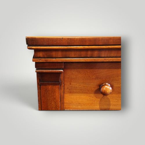 fig 2. A Victorian warm brown mahogany Wellington chest featuring four stacked drawers with turned wooden handles and a side locking bar.