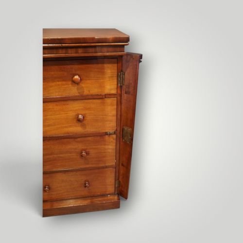 fig 5. A Victorian warm brown mahogany Wellington chest featuring four stacked drawers with turned wooden handles and a side locking bar.