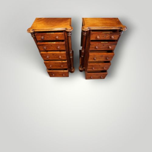 fig 2. A matching pair of narrow Victorian mahogany bedside chests featuring five graduated drawers with turned side columns on plinth bases.