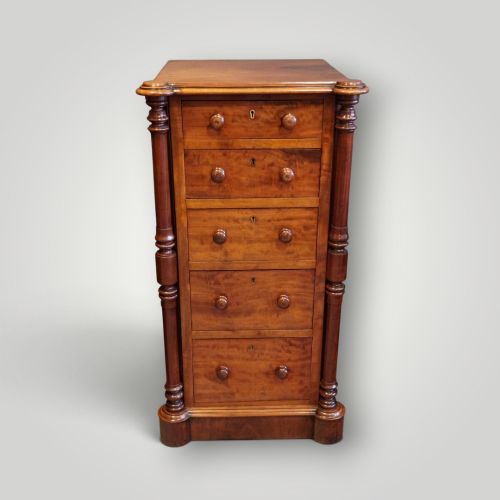 fig 4. A matching pair of narrow Victorian mahogany bedside chests featuring five graduated drawers with turned side columns on plinth bases.