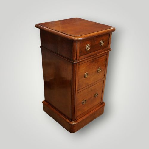 fig 1. A pair of matching Victorian mahogany bedside chests, each featuring three drawers with brass ring handles and a solid plinth base.