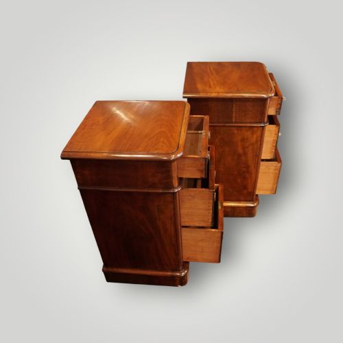 fig 4. A pair of matching Victorian mahogany bedside chests, each featuring three drawers with brass ring handles and a solid plinth base.