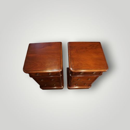 fig 7. A pair of matching Victorian mahogany bedside chests, each featuring three drawers with brass ring handles and a solid plinth base.