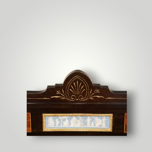fig 10. A Victorian ebonised and thuya wood pedestal desk featuring a leather writing surface, raised side drawers, ivory inlay, and ceramic plaque details.