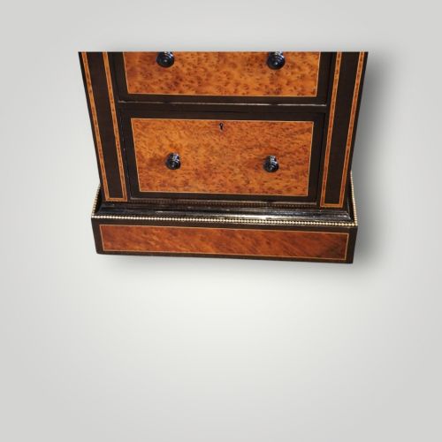 fig 11. A Victorian ebonised and thuya wood pedestal desk featuring a leather writing surface, raised side drawers, ivory inlay, and ceramic plaque details.