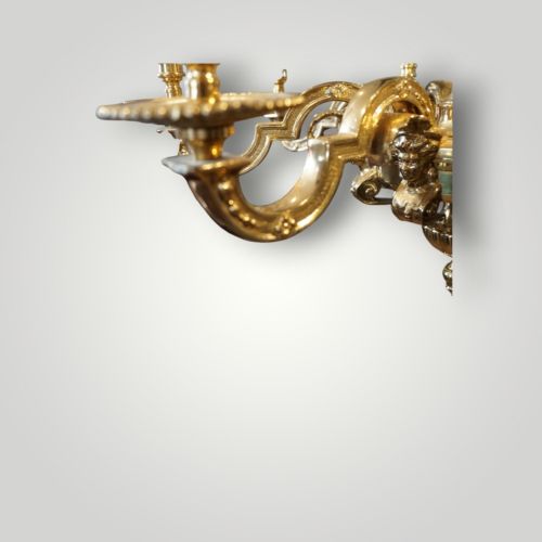 fig 1. A nineteenth-century French gilt bronze eight-light chandelier featuring a central urn column and scrolling candle arms with faux candle sleeves.