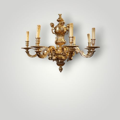 fig 5. A nineteenth-century French gilt bronze eight-light chandelier featuring a central urn column and scrolling candle arms with faux candle sleeves.