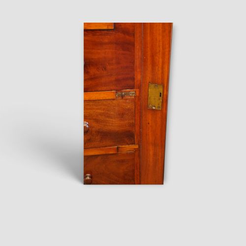 fig 3. A tall Victorian mahogany Wellington chest featuring seven drawer fronts, turned wooden knobs, and a right-hand side locking flap.