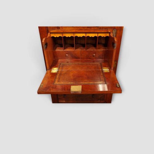 fig 5. A tall Victorian mahogany Wellington chest featuring seven drawer fronts, turned wooden knobs, and a right-hand side locking flap.