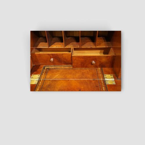fig 6. A tall Victorian mahogany Wellington chest featuring seven drawer fronts, turned wooden knobs, and a right-hand side locking flap.
