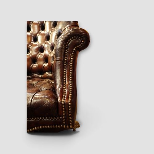 fig 1. A deep buttoned brown leather captains desk chair with brass studding trim and a dark mahogany swivel base on castors.