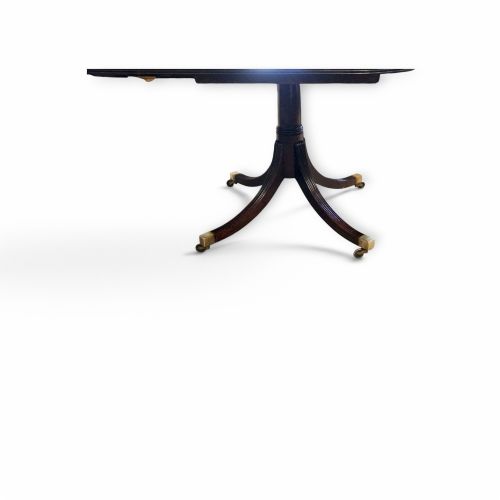 fig 6. A Georgian style dark mahogany dining table featuring an extendable top, twin turned pedestal pillars, and splayed quadruped legs with brass toe caps.