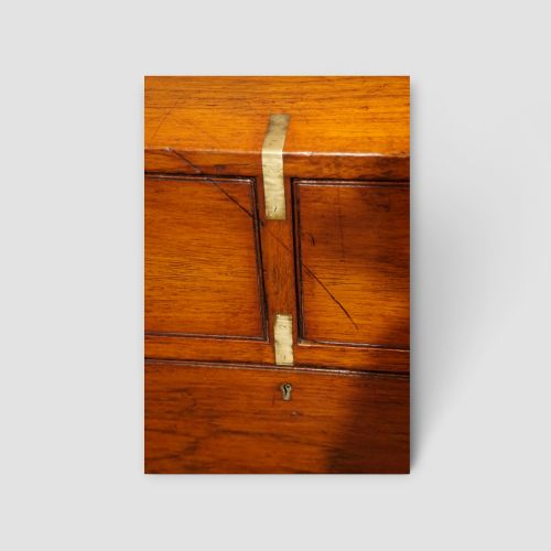 fig 8. A Victorian teak two-part military campaign chest of drawers featuring flush brass handles, brass corner mounts, and turned feet.