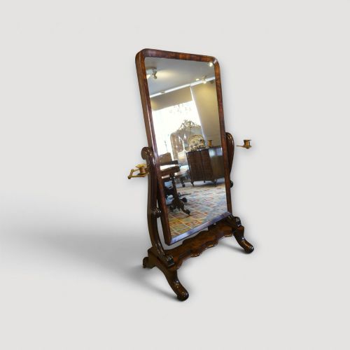 fig 1. A Victorian mahogany cheval mirror with a rectangular rounded tilting glass frame, dual upright supports, and a curved plinth base set on scroll legs.