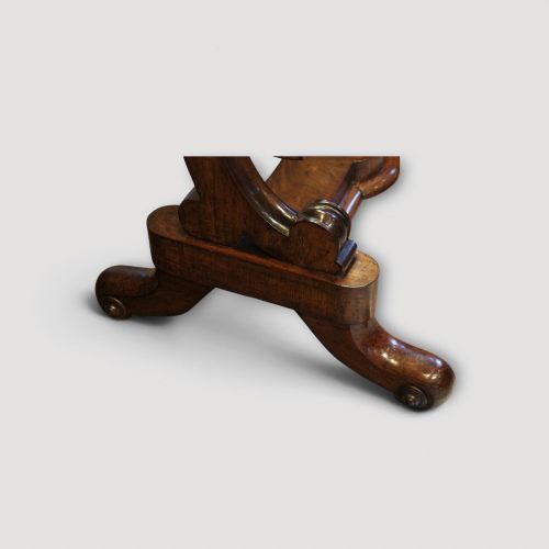 fig 5. A Victorian mahogany cheval mirror with a rectangular rounded tilting glass frame, dual upright supports, and a curved plinth base set on scroll legs.