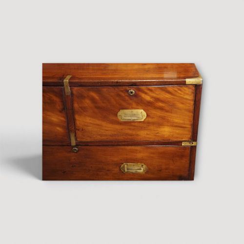 fig 3. A Victorian mahogany campaign chest featuring two short drawers over three long drawers with flush brass handles, brass corner brackets, and turned feet.