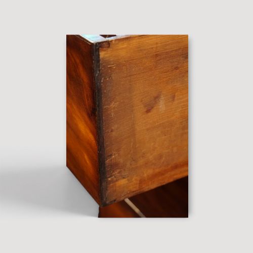 fig 4. A Victorian mahogany campaign chest featuring two short drawers over three long drawers with flush brass handles, brass corner brackets, and turned feet.