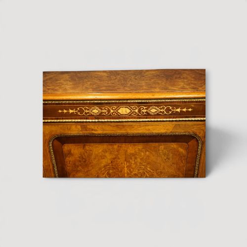 fig 8. A Victorian burr walnut credenza featuring a central marquetry inlaid door flanked by two curved glazed display side cabinets with gilt mounts.