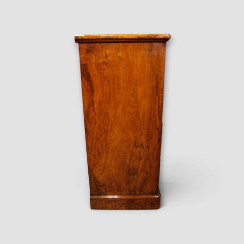 fig 5. A Victorian burr walnut chest of drawers featuring two short drawers over three long drawers with turned walnut knobs and a plinth base.
